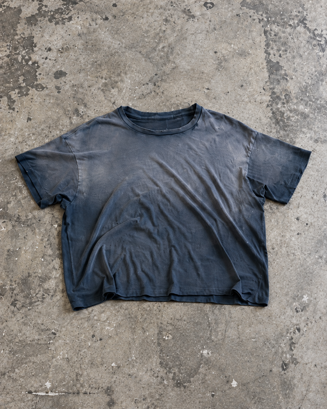 California Tee in Faded Navy, laid flat on concrete